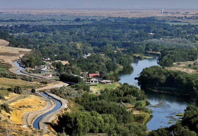 The Yakima River and an adjacent irrigation canal flows towards Richland in August 2025